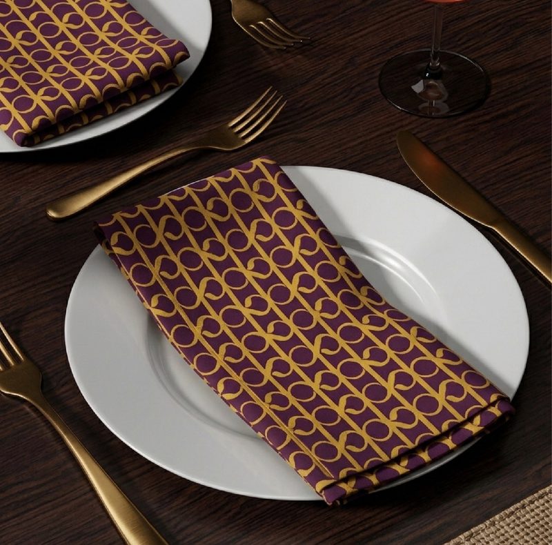 Kanakvira monogram pattern on a table napkin and place setting