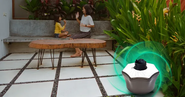 Mosquito trap on a patio where two people sit and talk. Mosquito Free World Google Ads creative by Sigil Advertising.