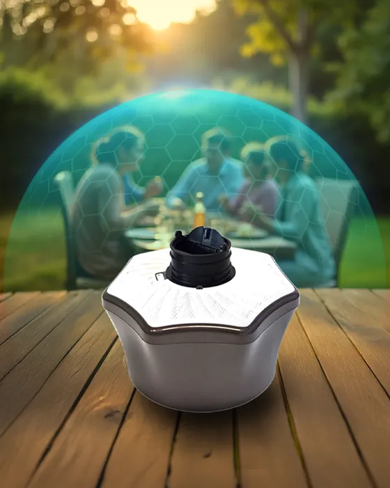 Mosquito trap on a wooden deck with a family dining outdoors at sunset. Mosquito Free World Google Ads creative by Sigil Advertising.